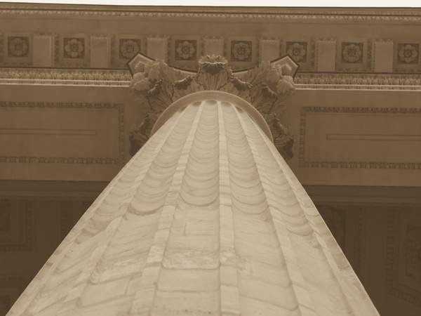 A fluted marble column with a carved capital.