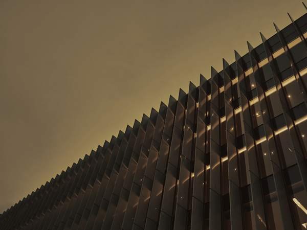 The glazed facade of a modern tower.